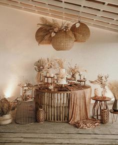 an arrangement of vases, candles and other items on a table in a room