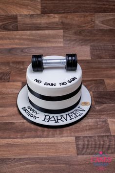 there is a cake that says no pain no gain on the top with dumbbells