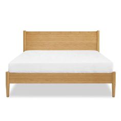 a bed with wooden frame and white sheets