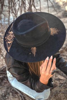 The perfect Fedora for any woman who loves the simplicity of black. This hat literally goes with any outfit and it timeless! It provides the intention of protecting your peace and happiness. The eye engraved on the front represents the symbol of protection. Handmade vegan suede black hat engraved with gorgeous gold detailing Size medium with elastic band that measures 22" around All hats are made in collaboration with Fonte Tulum in the jungle of Mexico by artisans. Not eligible for discounts, r Women’s Fedora, Protecting Your Peace, Symbol Of Protection, Black Fedora, Peace And Happiness, In The Jungle, Witchy Woman, Touch Of Gold, Fashion Costume