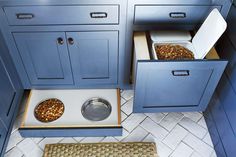 two bowls with food in them are sitting on the floor next to some cabinets and drawers