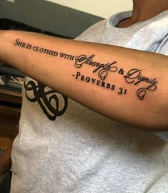 a woman with a tattoo on her arm that says she is clothed with glory and provers 31