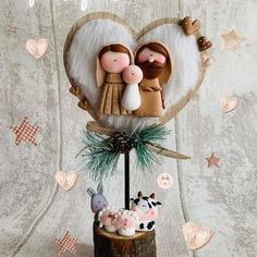 a wooden stand with two figurines in the shape of a heart on it