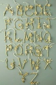 the letters and numbers are made out of gold leafy branches with flowers on them