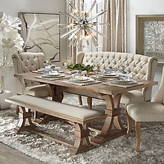 a dining room table with chairs and a bench