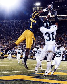 two football players jumping up in the air