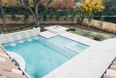 an empty swimming pool in the middle of a backyard