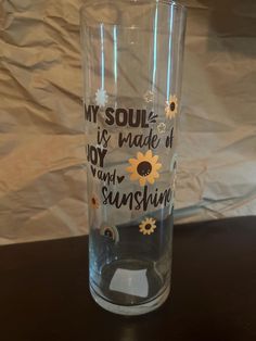 a clear glass with sunflowers and words on the side that says, my soul is made of joy and sunshine