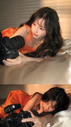 a woman laying on top of a bed with a camera next to her face and arm