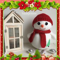 a christmas card with a snowman next to a doll house