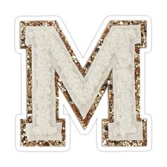 the letter m is made up of gold and white flowers sticker on a white background