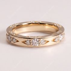 two gold wedding bands with diamonds on them