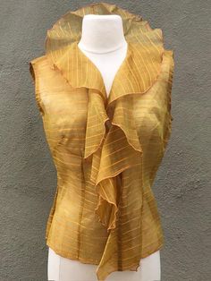 Gold Flutter Front Blouse. One of a kind peace silk. Hook front. Size medium. Spring Fitted Silk Chiffon Blouse, Spring Silk Chiffon Fitted Blouse, Chic Fitted Silk Chiffon Blouse, Summer Fitted Silk Chiffon Blouse, Fitted Silk Chiffon Blouse For Summer, Elegant Silk Chiffon Summer Tops, Chic Flowy Silk Blouse, Elegant Yellow Silk Blouse Piece, Silk Chiffon Summer Tops