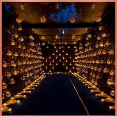 a room filled with lots of candles and lights hanging from it's ceilings