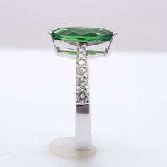 Set within an 18K white gold ring, this 2.29 carat Tsavorite, has a lush vivid green color. Known for their small sizes, the cutter has gained maximum from the rough, establishing a perfect marquise. Highlighted by the graduating diamond accents on either side of the tapered band, it is the perfect ring for delicate fingers. Order online info@jupitergem.com Graceful Hands, Tsavorite Ring, Anniversary Rings For Her, Ring Elegant, Marquise Ring, Tsavorite Garnet, Garnet Jewelry, Detailed Ring, Handcrafted Rings