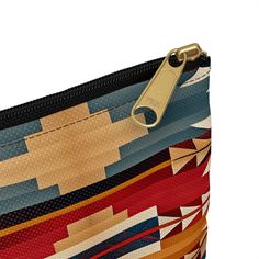 Inspired by the intricate artistry of traditional Native American design textiles, our pouch is a fusion of culture and functionality. Featuring warm sunset colors and captivating patterns, it's more than just a storage solution—it's a statement piece of heritage. Carry your essentials with style and cultural pride wherever you go! Our pouches vary from small to large and can be used for pretty much anything. They make excellent pencil cases and cosmetic travel bags. They are constructed of a du Bohemian Style Zipper Cosmetic Bag, Bohemian Cosmetic Bag With Zipper For Everyday Use, Bohemian Pouch Cosmetic Bag For Travel, Bohemian Cosmetic Pouch For Travel, Bohemian Cosmetic Bag For Travel, Bohemian Multicolor Travel Pouch, Bohemian Zipper Pouch, Multicolor Travel Pouch With Zipper Closure, Traditional Multicolor Zipper Pouch