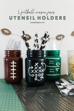 football mason jars with utensils in them sitting on a table next to a bowl of macaroni and cheese