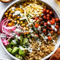 a white bowl filled with different types of salads and dressing on top of it