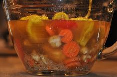 a pitcher filled with liquid sitting on top of a table