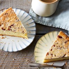 two plates with slices of cake on them next to a cup of coffee and fork