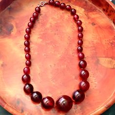 Elevate your style with this exquisite Vintage Cherry Amber Catalin Bakelite Phenolic Resin Beads Necklace 🌟 Made in Germany, this 50-gram beauty is a true statement piece! #VintageJewelry #BakeliteNecklace #GermanCraftsmanship 🌺✨  #Bakelite #Necklace 1950s Beaded Jewelry, Bakelite Necklace, Carnival Glass Vintage, 1950s Jewelry, Bakelite Jewelry, Vintage Cherry, Vintage Bakelite, Amber Jewelry, Resin Beads