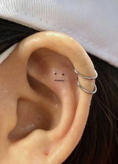 an ear with a small nose piercing on it