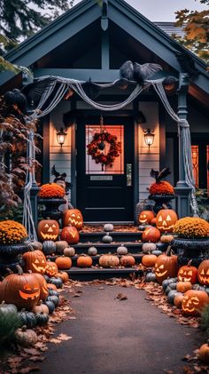 a house decorated for halloween with pumpkins and decorations