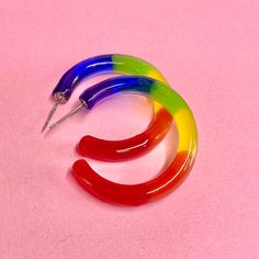 These Lovely LGBTQ+ Rainbow Pride Hoop Earrings are adorned with all 6 colors of the Pride Flag. Made with Resin and Hypoallergenic stainless steel ear posts, you are sure to stand out from the crowd! The Perfect statement piece to compliment your vibe.  These earrings are handcrafted with love in mind and light in my heart right in my home studio.  Makes a great gift for your bestie or to show love & support for a loved one! Flaunt Your Pride Year Round!  **Pairs great with our matching pride r