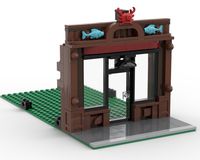 a small building made out of legos on top of a green mat with an elephant standing in the doorway