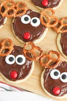 decorated cookies with chocolate frosting and pretzels in the shape of reindeers