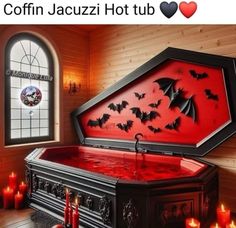 a red hot tub with bats on it in front of a stained glass window and candles