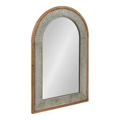 an arched mirror is shown against a white wall with wood trimmings and a wooden frame