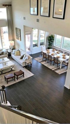 an aerial view of a living room and dining room from the second floor looking down