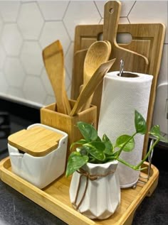 the kitchen utensils are sitting on the cutting board next to the toilet paper