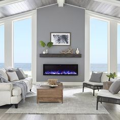 a living room filled with furniture and a fire place in front of a large window