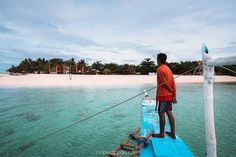 a man standing on top of a boat in the ocean