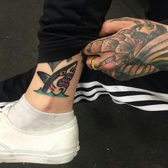 two people with tattoos on their legs holding each other's hands and showing off their matching tattoos