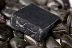 a black soap sitting on top of some rocks