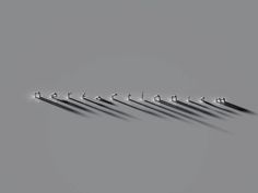 six metal hooks are lined up in a row on a gray surface with the word'm'spelled below them