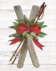 a christmas card with skis, holly and bow on the front is in white wood