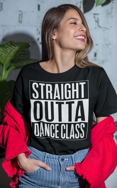 a woman wearing a black t - shirt with the words straight out dance class on it