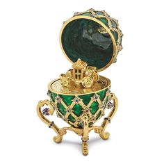 Elevate your jewelry storage with our exquisite Bejeweled Multi Color Finish ROYAL COACH Ring Holder Coach Inside Egg. This stunning piece features a pewter green and gold tone enamel finish, adorned with shimmering crystal stones for a touch of luxury.The ROYAL COACH design adds a regal touch to your vanity or dresser, while the convenient ring holder inside the egg allows you to keep your favorite rings safe and organized. Additionally, this set includes an 18-inch necklace pendant, perfect fo Faberge Jewelry, Faberge Egg, Egg Box, Faberge Eggs, Egg Art, Russian Art, Favorite Rings, Green Crystals, Decoration Design