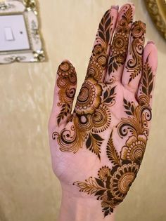 a woman's hand with henna on it