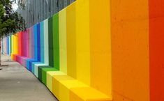 a rainbow colored wall on the side of a building