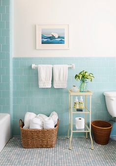 a bathroom with blue tiles and white towels