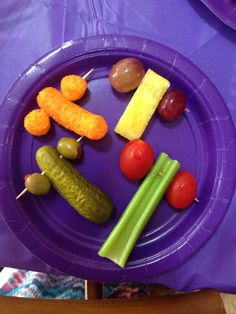 a purple plate topped with different types of vegetables