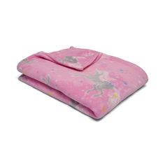 a pink blanket with unicorns on it is folded up and laying next to each other