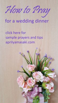 a vase filled with pink flowers sitting on top of a wooden table next to a sign that says how to pay for a wedding dinner