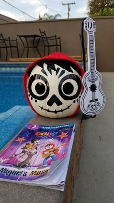 a stuffed animal with a guitar next to a pool