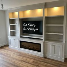 an entertainment center with built - in shelves and a fireplace